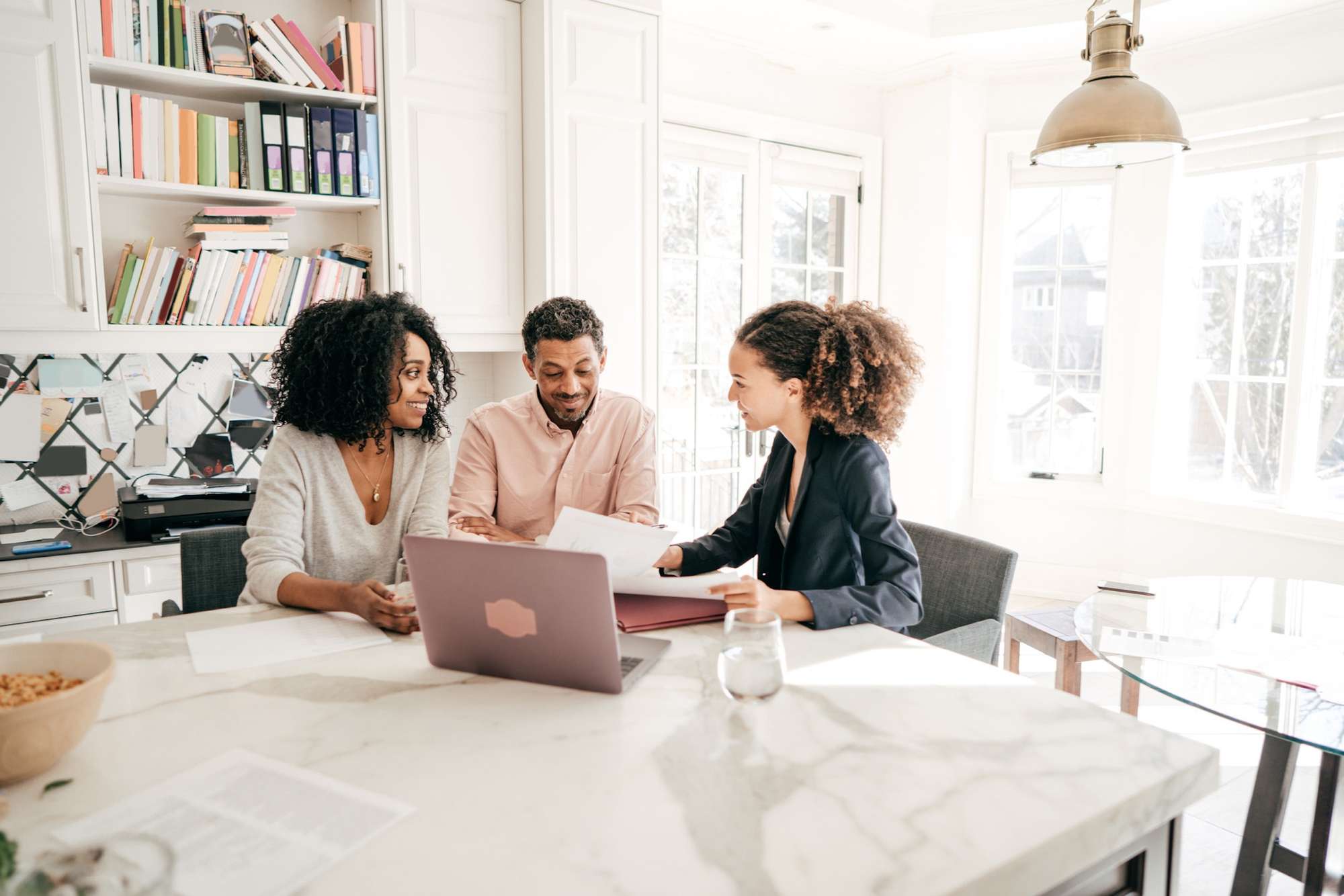 A tax professional meeting with clients at their home